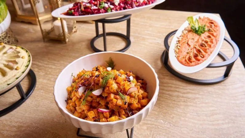 international-buffet-salads-and-mezze-at-noble-camp-dubai.webp